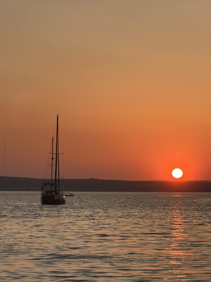 Boat at sunset off the Akbuk coastline