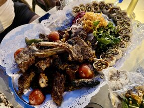 Table with Turkish meze and grilled fish overlooking the sea