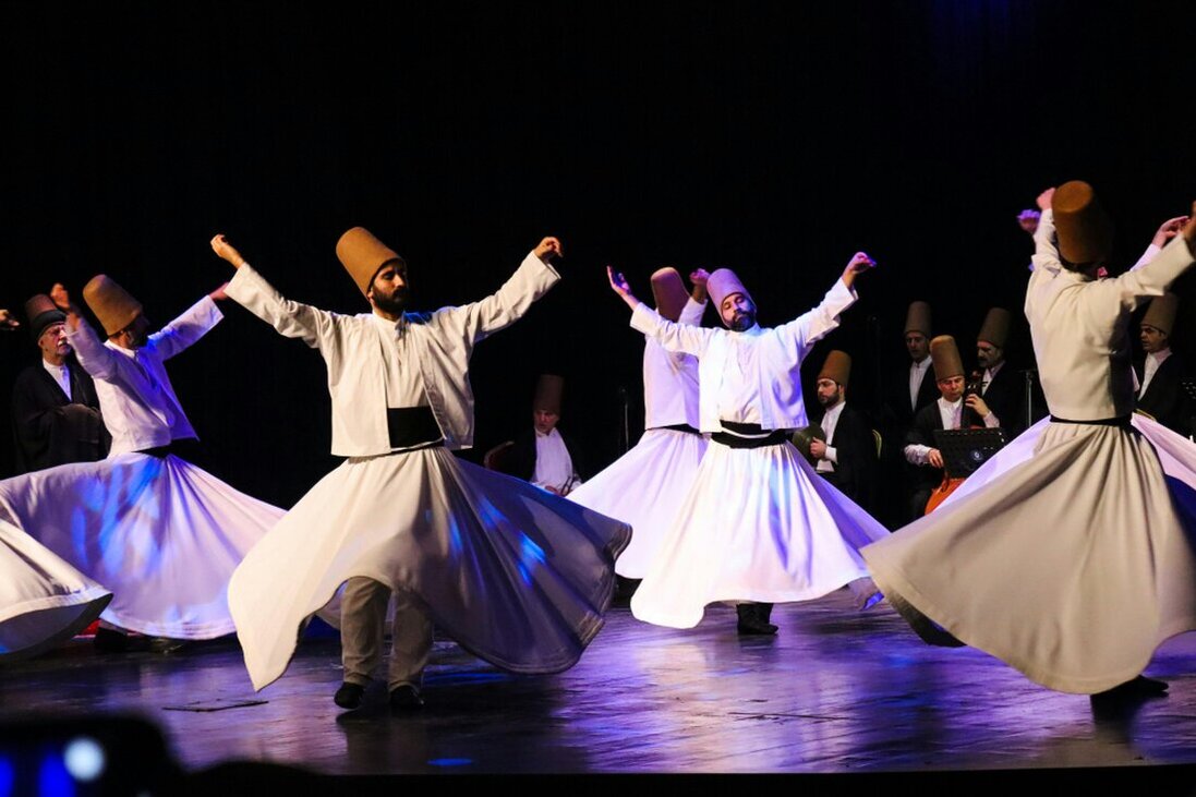 People dancing at an outdoor cultural festival in Turkey at night